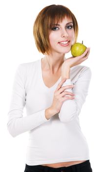 Portrait of a young beautiful woman with a green apple against white background