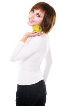 Portrait of a young beautiful woman with a green apple against white background