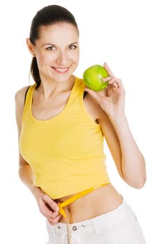 Beautiful slim woman holding a green apple, white background