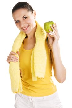 Beautiful young girl in sports outfit holding an apple, white background