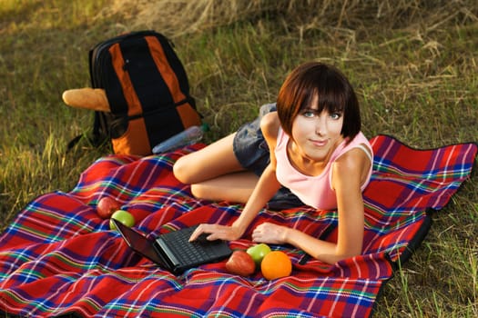 Lovely girl having a rest on picnic in the park 