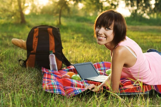 Lovely girl having a rest on picnic in the park 