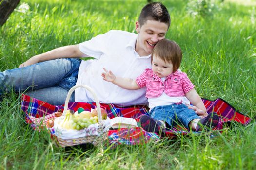 Young beautiful family on a picnic, natural light