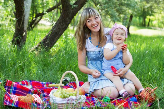 Cheerful mother with her daughter outdoor portrait