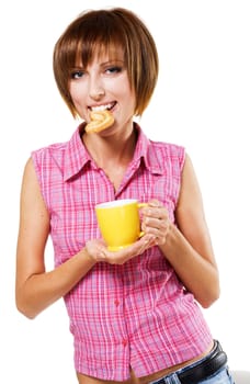 Cute girl with a tea cup biting a pretzel, white background 