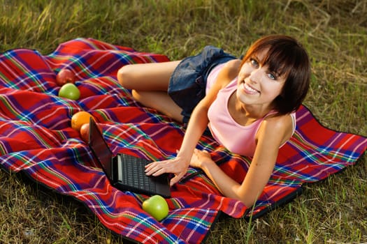 Lovely girl having a rest on picnic in the park 