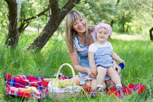 Cheerful mother with her daughter outdoor portrait