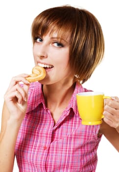Cute girl with a tea cup biting a pretzel, white background 