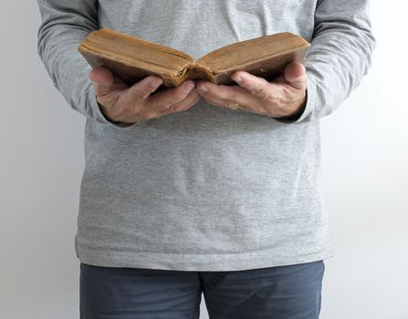 man reading old bible while standing