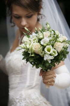 The beautiful bride with a wedding bouquet
