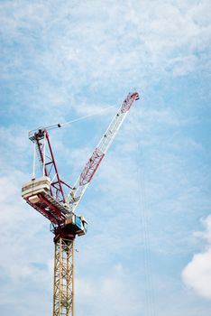 Construction crane against cloudy blue sky in Singapore