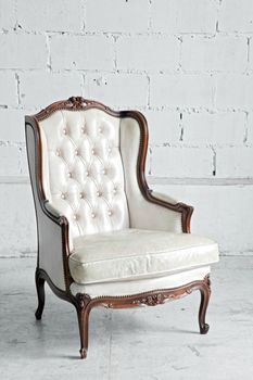 White genuine leather classical style sofa in vintage room