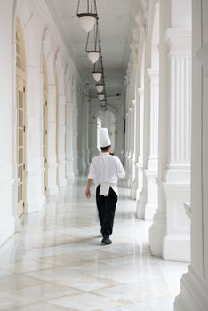 Singapore - September 08, 2012:Waiter in classical uniform in corridors of the Raffles Hotel. It is the oldest hotel in Singapore