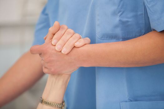 Nurse holding the hands and take care of the elderly woman