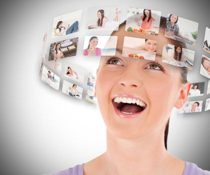 Woman viewing pictures around her head and smiling on grey background