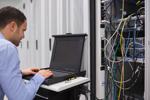 Man working with servers in data center