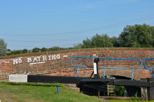 Canal bridge with no bathing sign