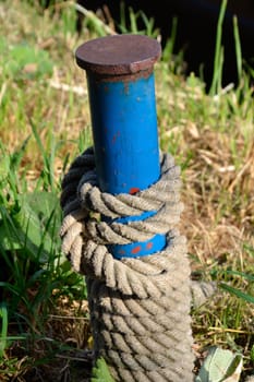 Blue post with coiled rope