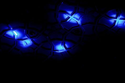 Generic shot of blue spot lights falling on a patterned surface creating shapes, angles, lines and form. Shot location was Goa India