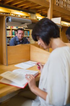 Man sitting at study desk in library