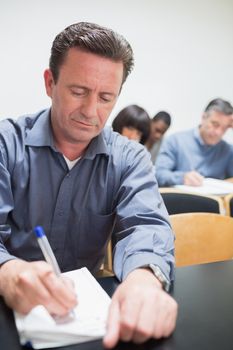 Man taking notes during the lesson