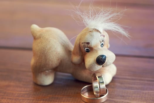 wedding rings on the background of dog figurines