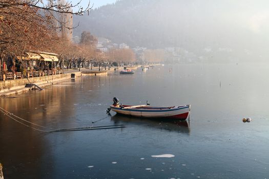 Boat in the lake in Autumn with little fog