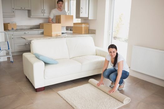 Two people moving into their house and furnishing the kitchen and living room