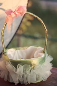 A wedding flower girl's basket with petals.