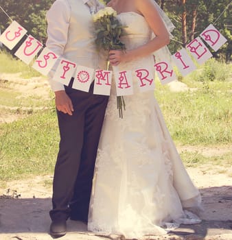 The bride and groom at a wedding with the words Just married