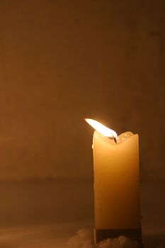 Closeup of burning candles outside in winter time