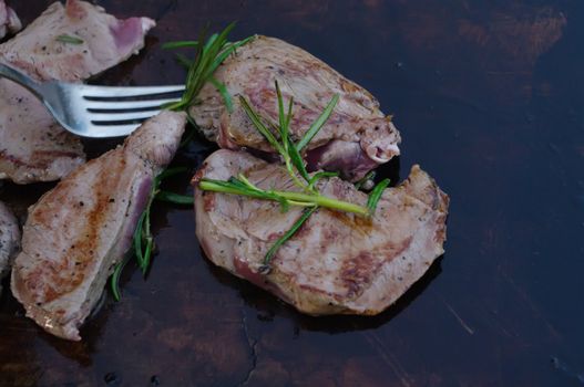 deer meat on bbq flagstone with rosemary