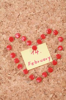 a valentine heart made of thumb tacks on a corkboard...........