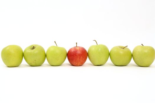 apples arranged on a white background to symbolize teamwork, leadership, discrimination............