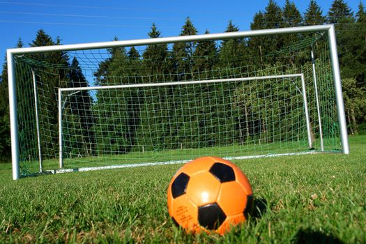 Goal. a soccer ball in a net. outdoors