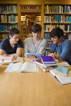 Men looking at tablet computer at the library