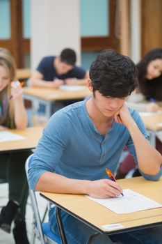 Student taking exam in exam hall in college