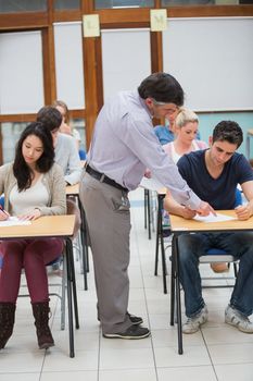 Lecturer helping student in classrom