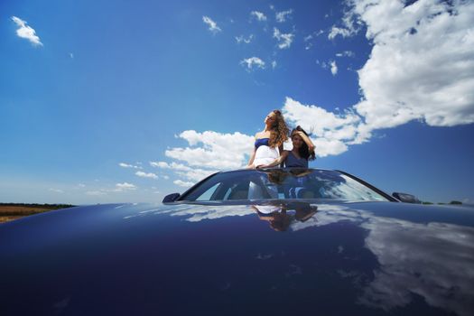 women dance in car