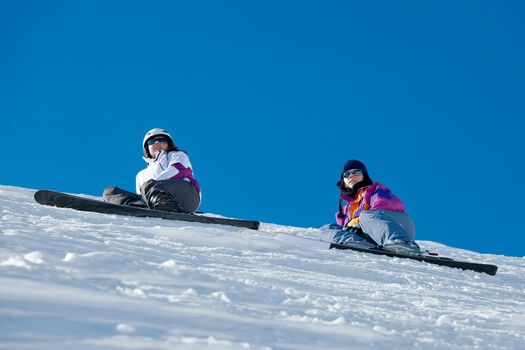 Skiers resting on the slope