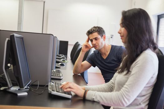 Students sitting at the computer room in college