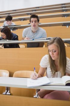 Student looking at another students work sneakily in lecture hall