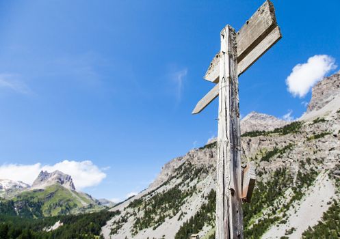 Italian Alps, close to Bardonecchia town. Mountain direction sign during a sunny day in summer season.