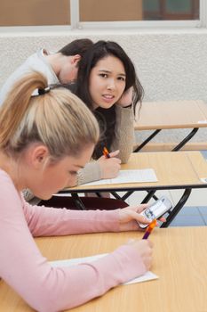 Woman sitting at the desk at the classroom needing help