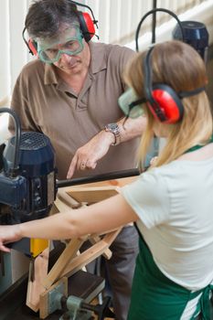 Student standing at a machine working 