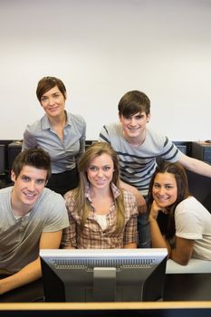 Happy teacher with her computer class in college