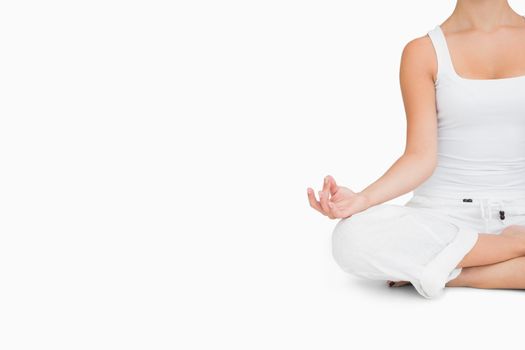 Woman doing yoga pose while sitting cross legged