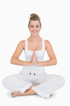 Girl sitting cross-legged smiling in yoga pose