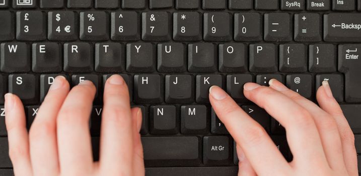 Woman hands typing on a screen