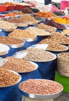 Market stall in Turgutreis (Turkey) offering a variety of dried fruit including almonds, walnuts, pistachios, peanuts, pumpkin seeds, raisins, etc.